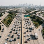 Houston I-45 and Loop 610 interchange showing heavy freeway traffic, merging vehicles, commercial trucks, and complex highway connections